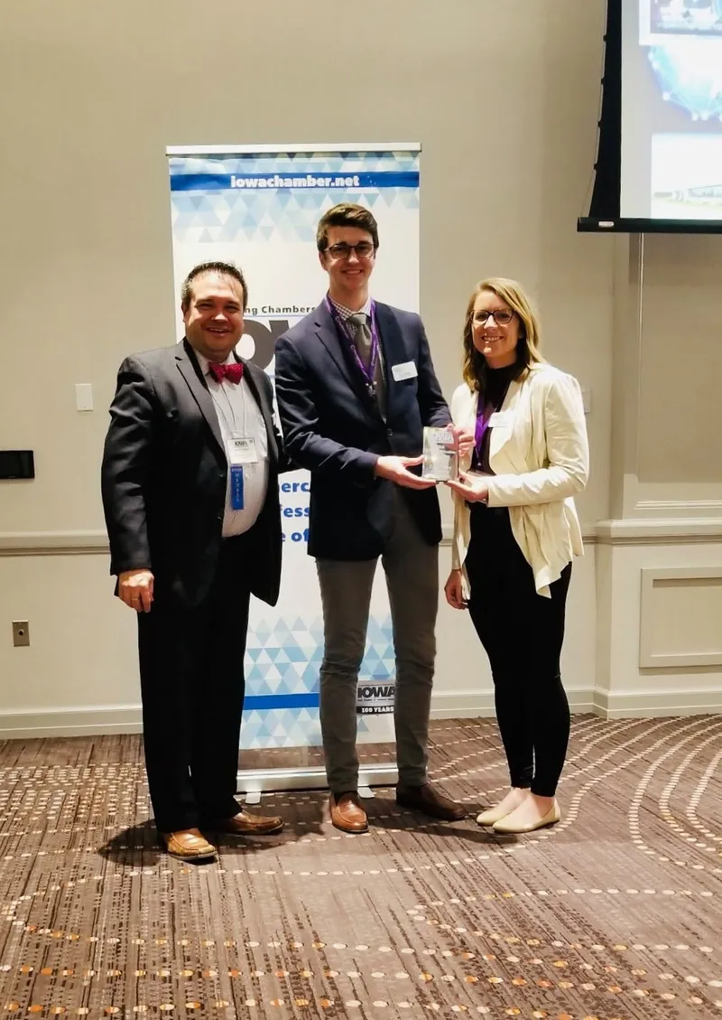 Aaron Jarnagin holding the 2018 Publication of the Year award with two colleagues